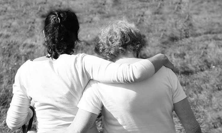 Two people hugging each other.