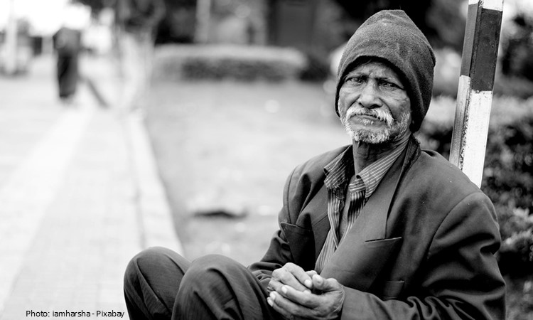 An old man sitting down.